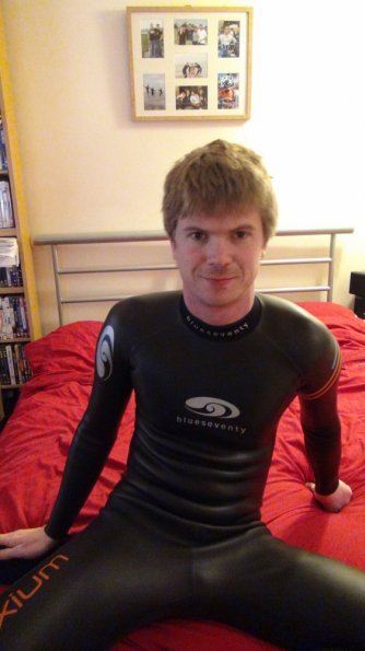 Wetsuited on bed